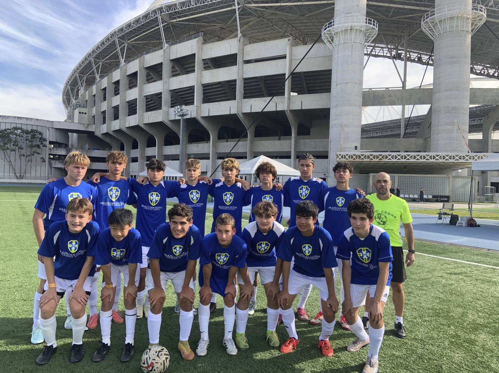Tour squad together on the field outside a Rio stadium